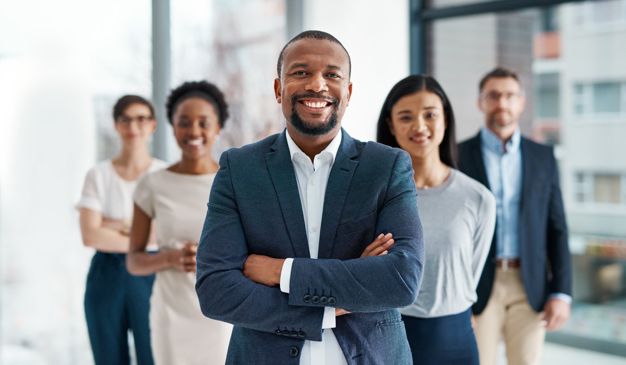 Professional, diverse business team, leader up front AdobeStock_522944332